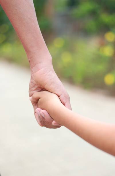 istock Family support - father hold child hand with love 1149785250