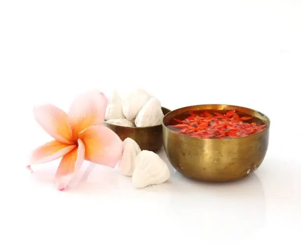 Thai Songkran festival - Group of bowl of water,flower and clay  on white