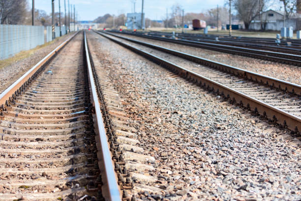istock Selective focus railway goes straight ahead at sunny spring daytime to blue haze horizon background with copy space 1149792925