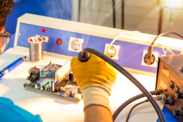 istock Electronics repair service, repairman fixes an electronic circuit, text space. 1149798335