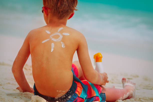 istock sun protection- boy with suncream at beach 1149799065