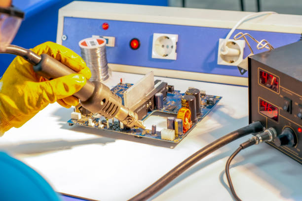istock Electronics repair service, repairman fixes an electronic circuit, text space. 1149799174