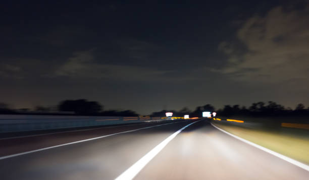 istock Car Trails on a Highway by Night 1149800474