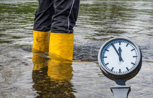 istock Wellies in the flood with clock 1149801898