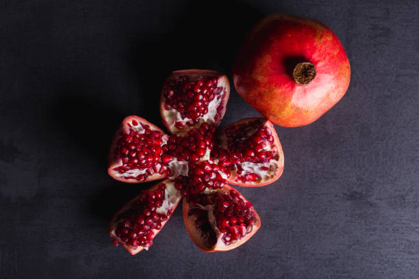 istock Fresh pomegranate fruits in dark scenery. 1149808905