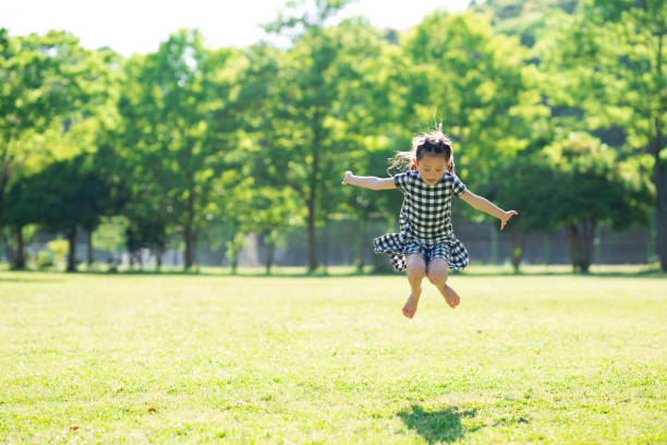istock Girl jumping on the grass 1149809240