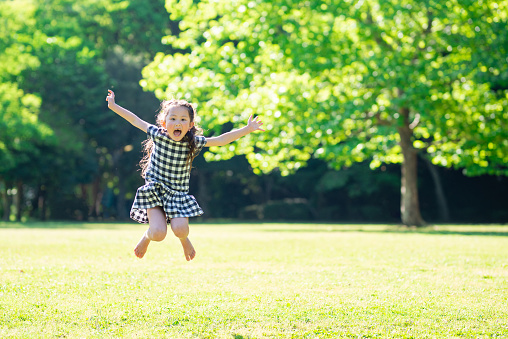 Girl jumping on the grass