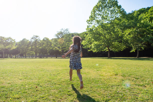 istock Girl running on the grass 1149809409