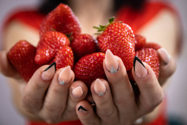 istock Strawberries in woman's hands 1149816555