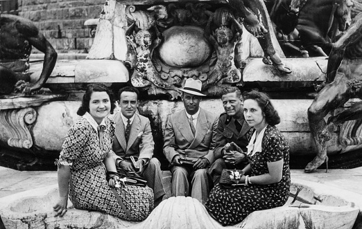 Group of elegant dressed couples having fun visiting Rome in the 1936.Italy.