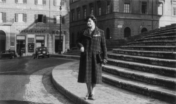 Elegant dressed lady having fun visiting Rome in the 1936. Fontana di Trevi, Rome. Italy.