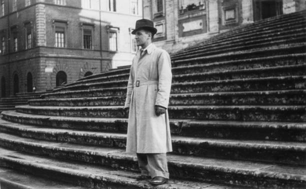 Elegant dressed man having fun visiting Rome in the 1936. Fontana di Trevi. Italy. Elegant dressed lady having fun visiting Rome in the 1936.Italy. 1930s style men image created 1920s old fashioned stock pictures, royalty-free photos & images