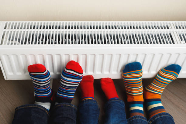 istock legs with colorful socks on heating radiator 1149820370