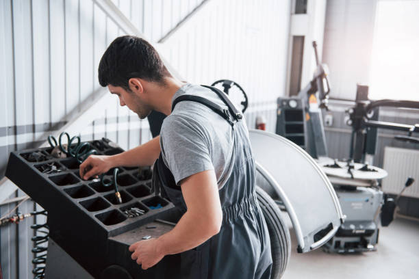 istock Picking right tool. Young man works with wheel's disks at the workshop at daytime 1149820790