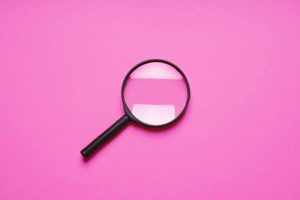 istock magnifying glass magnifier loupe search symbol on pink background 1149820830