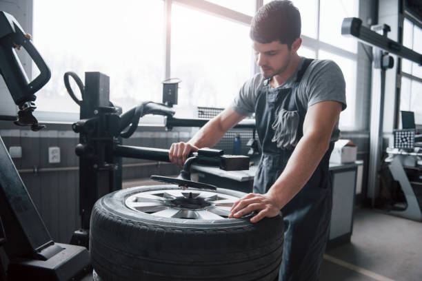 istock Little sunlight from the window. Young man works with wheel's disks at the workshop at daytime 1149820907
