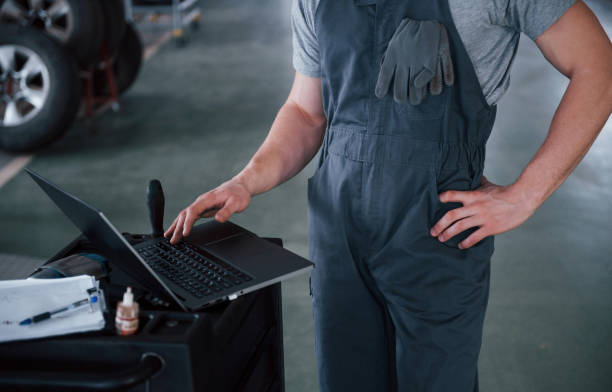 istock Body only. Worker stands indoors in uniform does reports, calculations and looking at the plans 1149821080