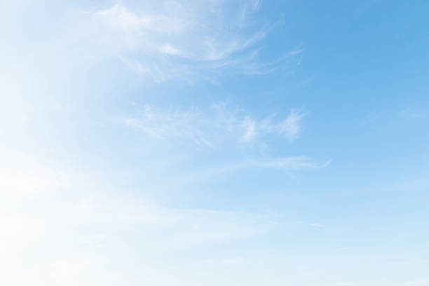 Beautiful clear blue sky background with plain large white cloud on morning time rays sunlight. space for text. soft focus.