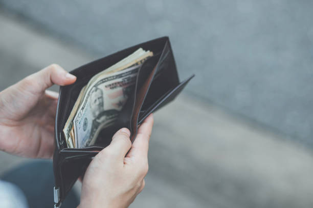 istock Man holding a wallet with money 1149822961