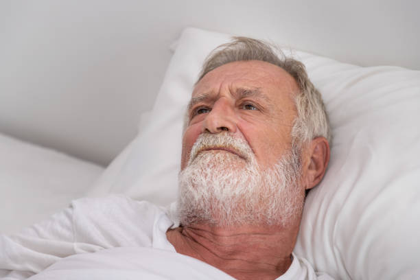 istock Senior elderly man on bed eye open sleeplessness with white blanket in bedroom 1149827004