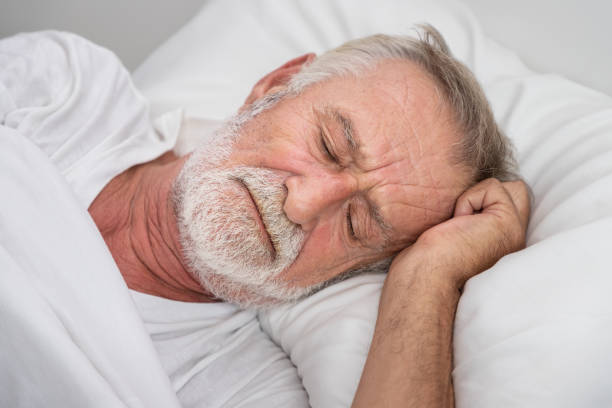 istock Senior elderly man on white bed, sleep with worry,  in bedroom 1149827008