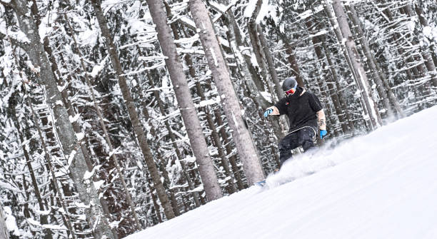 istock Let’s do it! Snowboarder is riding down from the mountain on his snowboard 1149827150