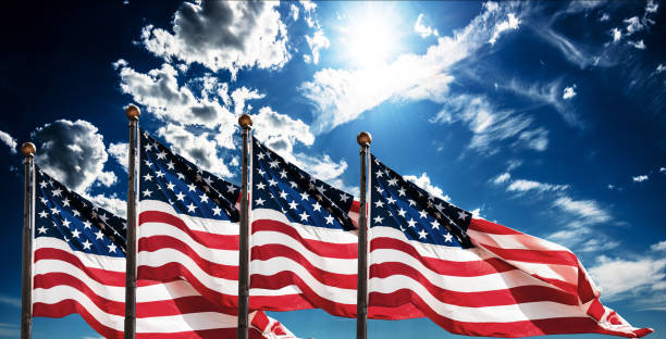 american flags against the sky for the memorial day american flags against the sky veteran photos stock pictures, royalty-free photos & images