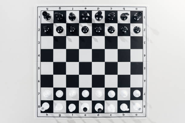istock top view of black and white chessboard with chess figures on white background 1149832586