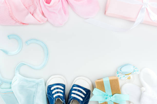 istock top view of booties and sneakers, pacifier, gift boxes and bonnets on white background 1149834976