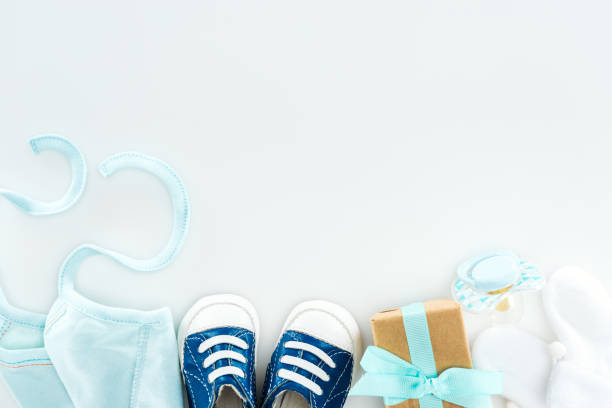 istock top view of booties and sneakers, pacifier, gift box and bonnet on white background 1149834979