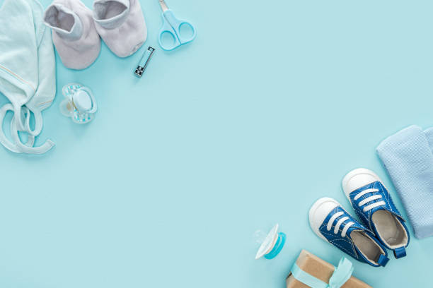 istock top view of scissors, pacifiers, gift, sneakers, bonnet, booties, hat on blue background 1149835074