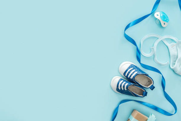 istock top view of pacifier, gift, sneakers, bonnet, ribbon on blue background with copy space 1149835080