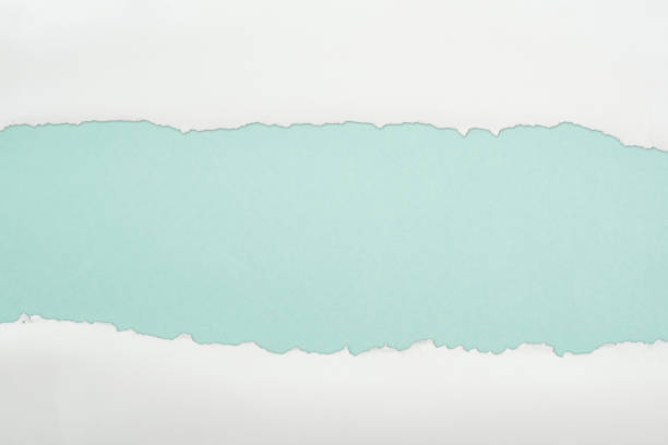 istock ragged and white paper with copy space on light blue background 1149835600