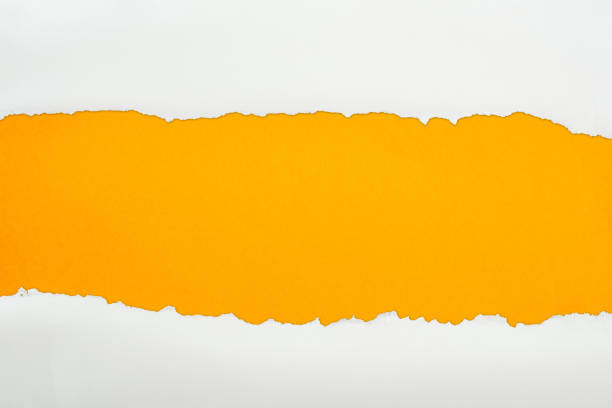 istock ragged white textured paper with copy space on orange background 1149835603