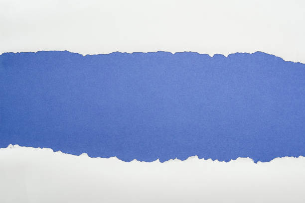 istock ragged white textured paper with copy space on deep blue background 1149835614