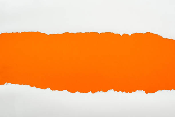 istock ripped white textured paper with copy space on orange background 1149835783