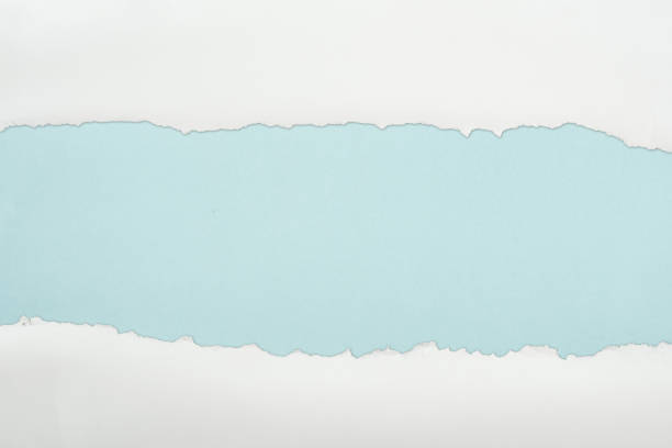 istock ripped white textured paper with copy space on light blue background 1149835792