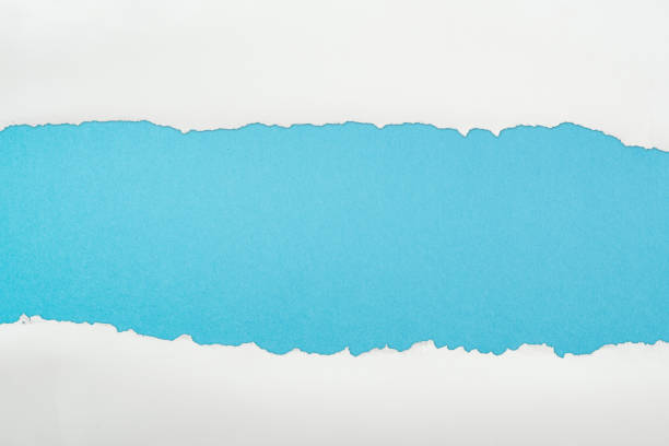 istock ragged and textured paper with copy space on blue background 1149835821