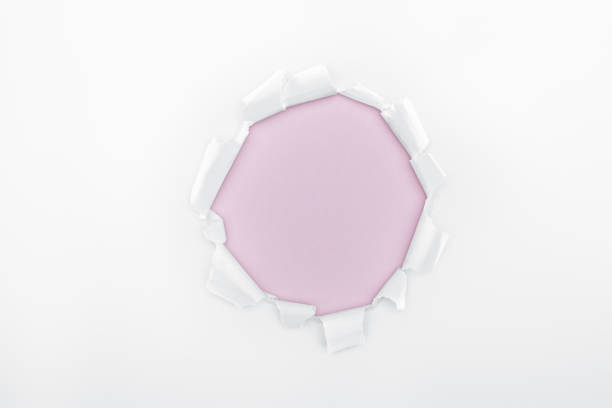 istock ripped hole in white textured paper on pink background 1149836672