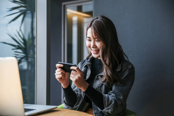 istock Young women playing mobile game and selfie 1149838828