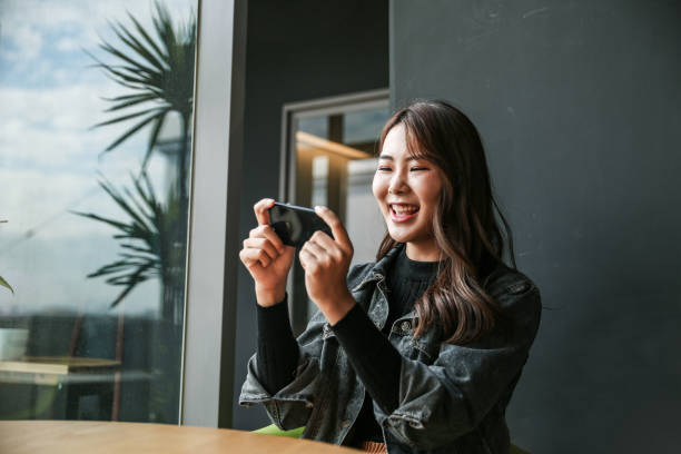 Young women playing mobile game and selfie