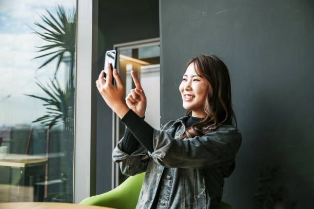istock Young women playing mobile game and selfie 1149839009