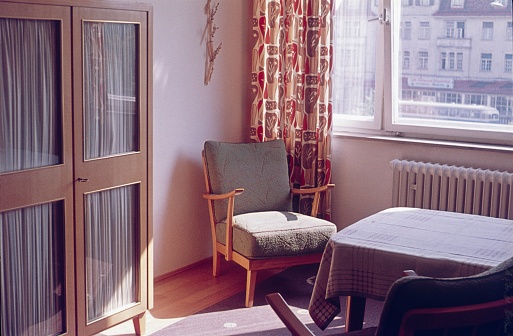 Goslar, Lower Saxony, Germany, 1958. Old living room with open window in spring.