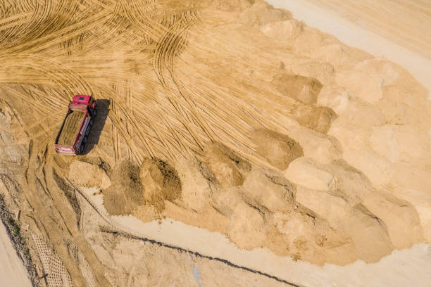 istock Industrial truck loader excavator moving earth and unloading. Aerial view 1149856047