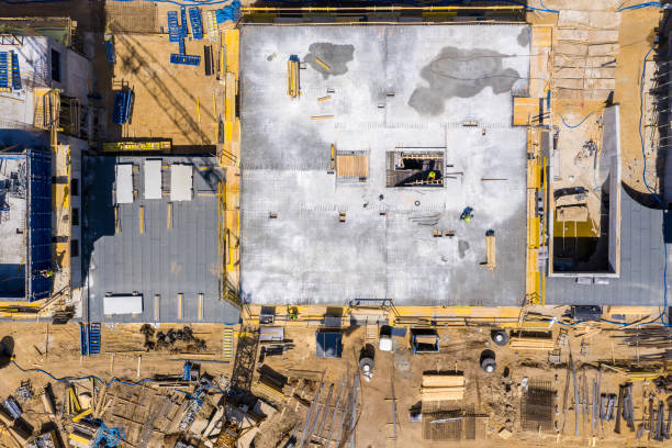 istock Construction crane next to the house under construction from a height, aerial view 1149856195