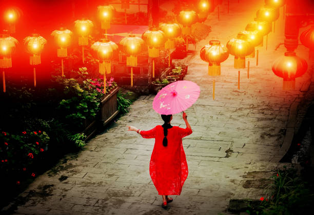 A woman in traditional costume on an ancient street in haiwozi ancient town, pengzhou city, sichuan province, China.