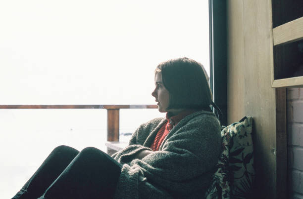 istock Teenager looking out the window 1149871412