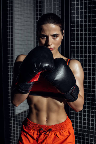 istock Front view of concentrated boxer in boxing gloves looking at camera 1149877046