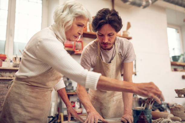 istock Serious skilled man and woman focusing on work 1149878971