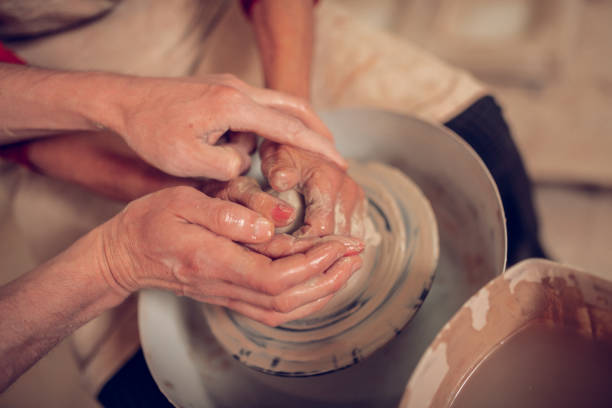 istock Top view of human hands in clay 1149879034